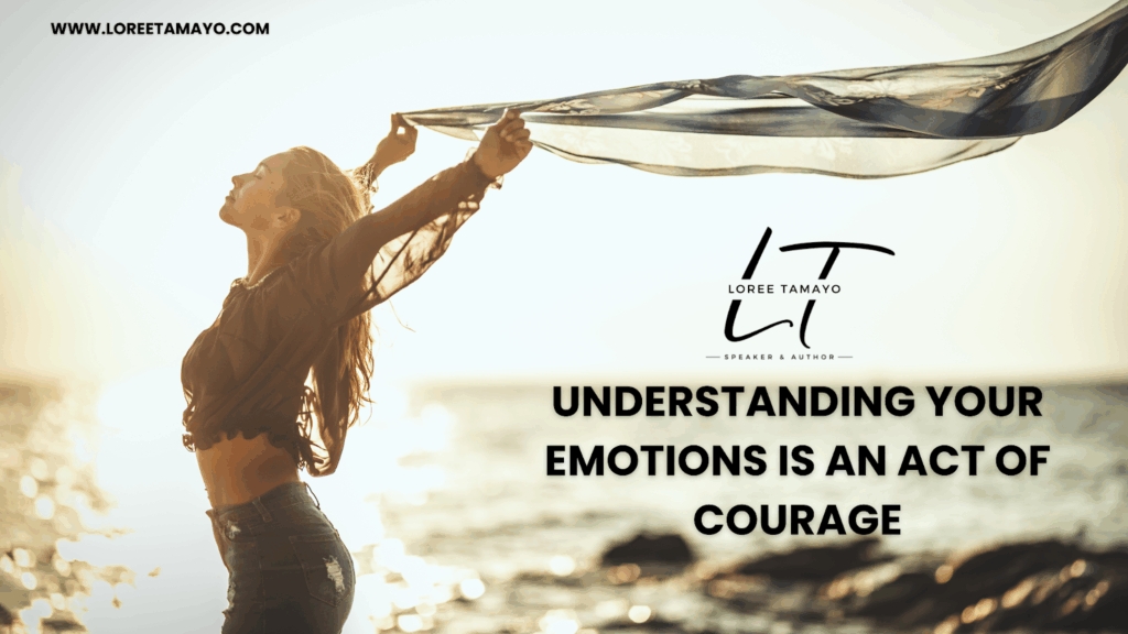 A woman stands at the ocean’s edge at sunset, lifting a flowing scarf above her head as she breathes in with a sense of freedom and calm. The Loree Tamayo logo appears on the right, with the text: ‘Understanding your emotions is an act of courage.’ The website www.loreetomayo.com is displayed at the top left.