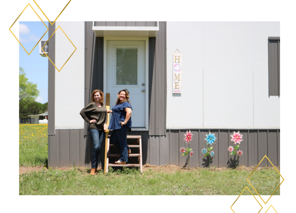 Loree and a team member in front of a home at Yesterday's Gone