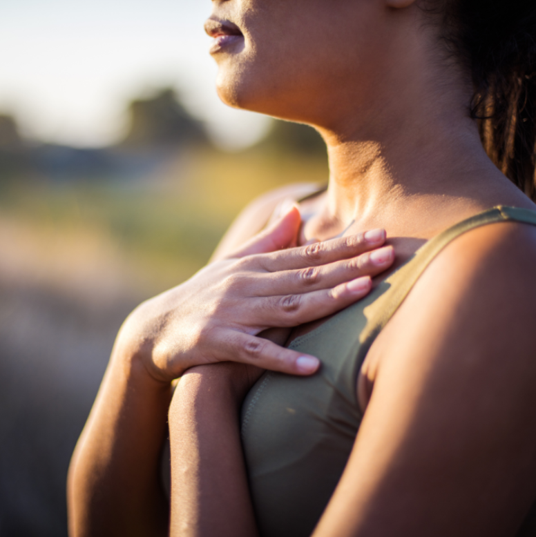 A woman uses a simple grounding technique that really works by placing her hands over her heart to calm her nervous system and reconnect with the present moment.